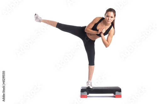 Fotografie, Obraz Young slender brunette exercising on stepper