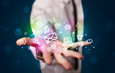Poster - Young businessman presenting colorful glowing social media icons