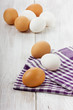 White and brown eggs on a linen napkin