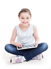 Portrait of little girl sitting with the tablet.