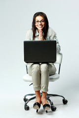 Sticker - businesswoman with laptop sitting on chair on gray background