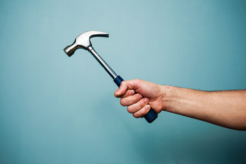 Man's hand holding hammer