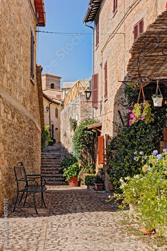 Naklejka - mata magnetyczna na lodówkę alley with flowers of a small town in Umbria, Italy