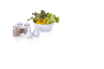 Wall Mural - bowl of vegetables and seasoning bottles isolated on white