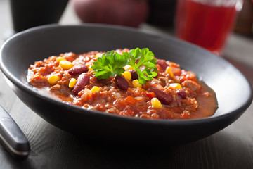 Wall Mural - mexican chili con carne in black plate