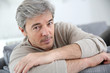 © goodluz - Portrait of mature man relaxing at home in sofa