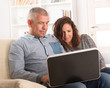 © Monika Wisniewska - Couple using laptop at home