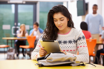 Female Teenage Student In Classroom With Digital Tablet