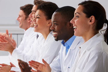 Technician And Colleagues In Laboratory Clapping