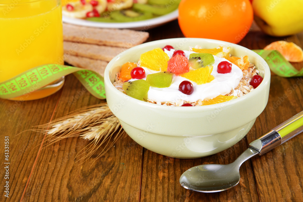 Delicious oatmeal with fruit in bowl on table close-up