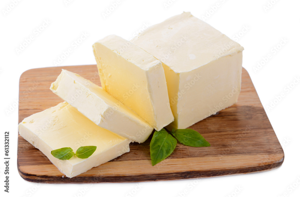 Tasty butter on wooden cutting board isolated on white