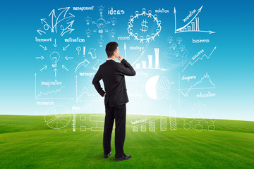 Wall Mural - Businessman looking to the future creative drawing charts