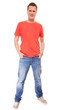 © Voyagerix - Young man guy red t-shirt jaens with hands in pockets isolated