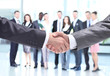 © opolja - Closeup of business people shaking hands over a deal