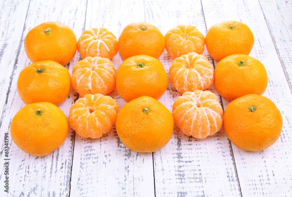 Ripe sweet tangerines on color wooden background