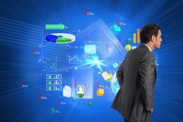 Poster - Composite image of serious businessman with hands on hips