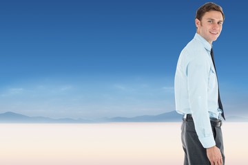 Poster - Composite image of happy businessman standing with hand in