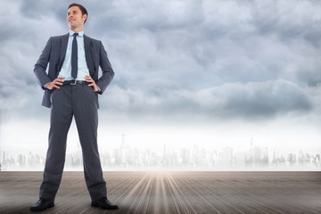Poster - Composite image of happy businessman with hands on hips