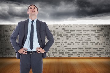 Poster - Composite image of smiling businessman with hands on hips