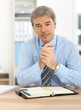 © goodluz - Portrait of mature businessman in office