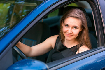 Wall Mural - Beautiful businesswoman sitting in the car