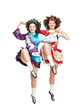 © darkbird - Two young women in irish dance dress dancing isolated