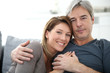 © goodluz - Middle-aged couple relaxing on sofa at home