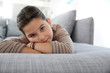 © goodluz - Portrait of sad little girl laying on couch