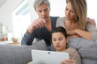 © goodluz - Parents websurfing on internet with daughter