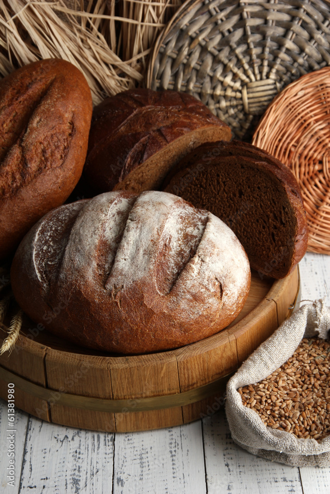 Rye bread on wooden stand on wicker background