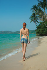 Beautiful girl walking on the beach