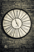 Old Vintage Clock In Monochrome On Textured Brick Wall