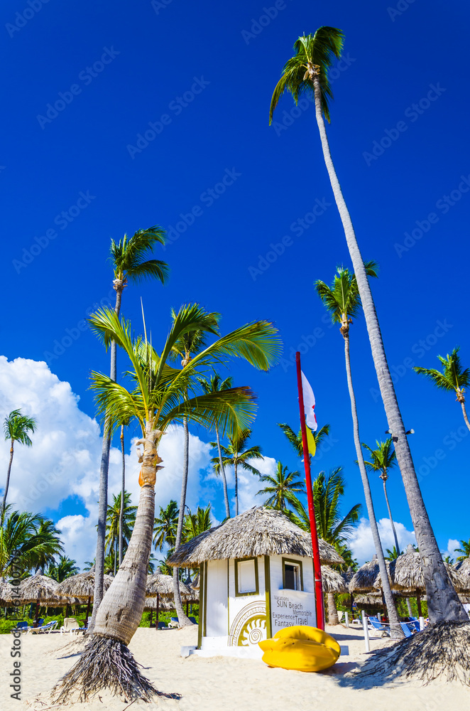 Holiday cottage and yellow kayak on Dominicana beach - obrazy, fototapety, plakaty 
