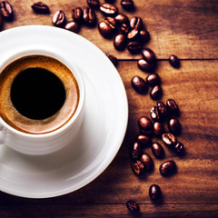 Poster - Coffee cup with white saucer and roasted coffee beans  on wooden