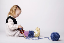 Cute Little Girl Knitting Scarf