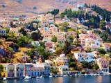 Fototapeta  - Colorful houses on hill, Symi island, Greece