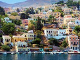 Fototapeta  - beautiful houses on hill, Symi island, Greece