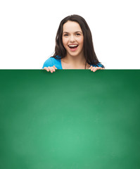 Wall Mural - smiling young girl with blank white board