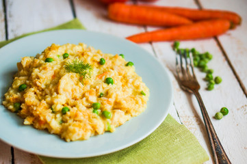 Wall Mural - Rice with vegetables and chicken on white wooden background