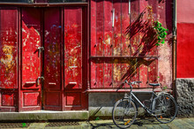 Red Wooden Wall With Door And Bicycle