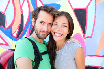 Wall Mural - Happy couple selfie portrait, Berlin Wall, Germany