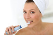 © goodluz - Woman brushing her teeth with electrical toothbrush