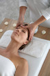 © goodluz - Woman having a face massage in beauty institute