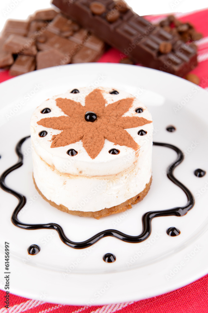 Sweet cake with chocolate on plate on table close-up