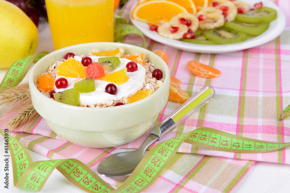 Delicious oatmeal with fruit in bowl on table close-up
