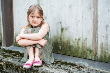 angry little girl portrait outdoors