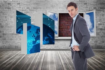 Poster - Composite image of serious businessman with hands on hips