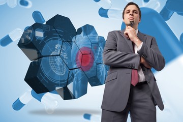 Poster - Composite image of thinking businessman holding his glasses