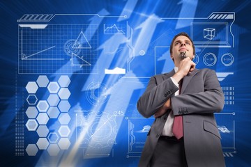 Poster - Composite image of thinking businessman holding his glasses