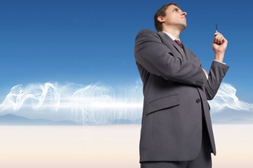 Poster - Composite image of thoughtful businessman holding pen